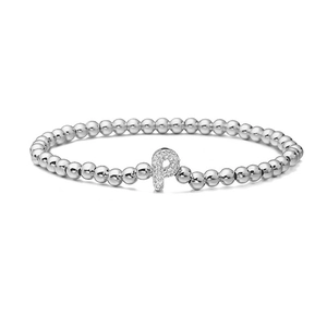 Macro detail of silver beaded stretch bracelet with micro-pave zircon letter P charm