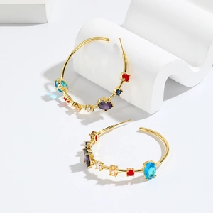 Luxury gold C-shaped hoop earrings with colorful zircon stones on white display