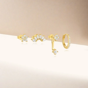 Macro shot of S925 sterling silver gold plated earring set with white zircon stones