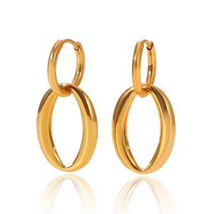 Macro shot of gold double-hoop earrings with polished oval drops on a white background