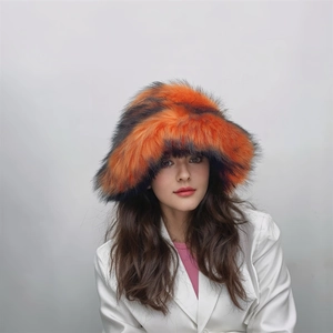 Close-up of fluffy orange and black striped faux fur texture on thick winter bucket hat