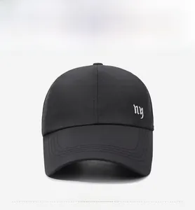 Close-up of NY embroidery on lightweight breathable black mesh fabric baseball cap
