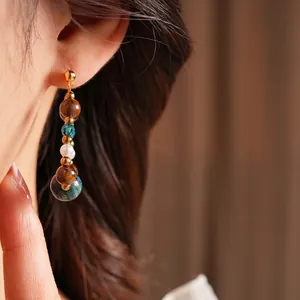 Retro tiger eye drop earrings with pearls and blue crystals for a vintage aesthetic