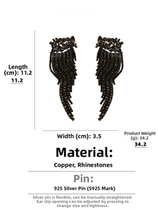 Detail view of oversized tassel earrings showing dimensions of 11.2cm length and 3.5cm width