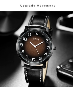Macro view of brown gradient dial and black leather strap on a men's quartz watch