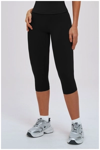 Detail view of high-waisted black yoga capri pants with slimming athletic stitching