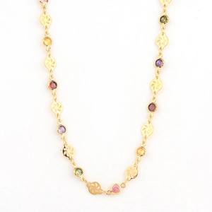 Close-up of gold-plated necklace featuring colorful crystals and hollow floral gold discs