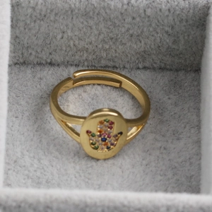 Polished gold-plated Hamsa hand open ring with colorful zircon stones in a jewelry box