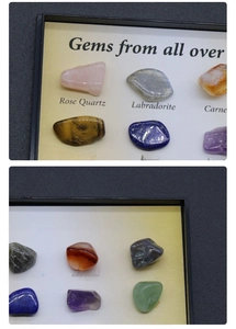 Detailed collection of assorted polished natural gemstone specimens in a labeled display box