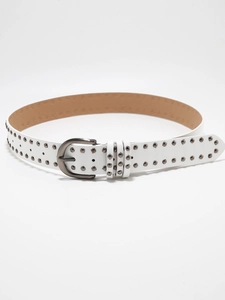 Macro shot of white leather Y2K belt featuring double-row silver metal studs and pin buckle