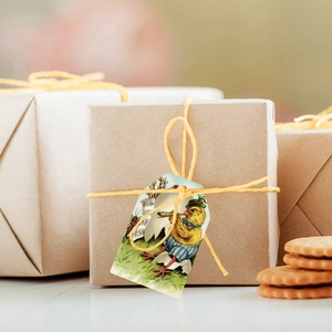 Close-up of vintage Easter gift tag with chicken illustration on brown kraft paper box