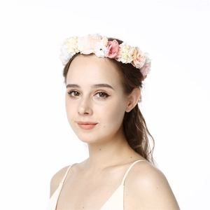 Floral wreath headpiece with pink and cream silk roses on a model in a portrait view