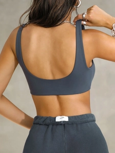 Rear view detail of dark grey sports bra with U-back design and terry cloth waistband shorts