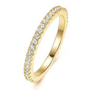 Macro detail of gold eternity ring with single row of cubic zirconia stones