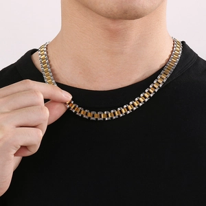 Close-up of a men's two-tone gold and silver steel watch-style link necklace on a model