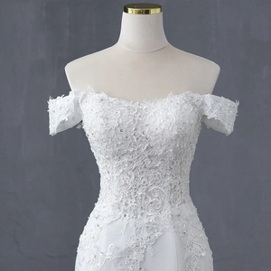 Elegant off-shoulder mermaid wedding dress with floral lace and shimmering sequins