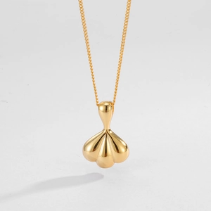Close-up of golden shell fan pendant with polished mirror finish on S925 silver chain