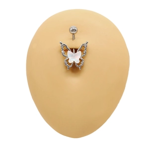 Macro shot of silver butterfly navel ring with white gems on a silicone skin model