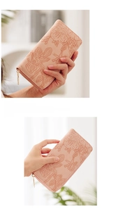 Macro detail of pink floral embossed wallet with premium gold zipper and leather texture