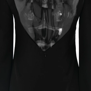 Close-up of invisible back zipper on black satin mini dress with slim fit back design