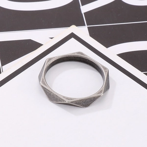 Macro detail of geometric rhombus ring in antique silver finish on a modern backdrop