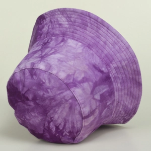 Detailed view of reinforced brim stitching on a purple tie-dye cotton bucket hat