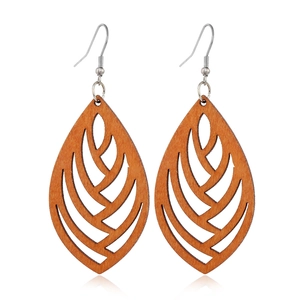 Macro shot of brown wood hollow geometric leaf earrings with silver metal hooks
