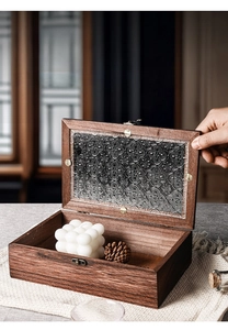 Macro view of vintage wooden jewelry box featuring embossed begonia pattern glass and metal clasp