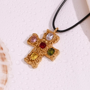 Detailed close-up of 18K gold-plated cross pendant with five colorful oval gemstones