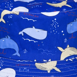 Navy blue reversible bucket hat with cartoon whale and dolphin prints for sun protection