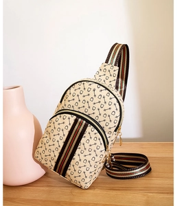 Detail view of beige crossbody bag with horsebit print and iconic red-green web strap