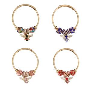 Detailed grid view of four colorful bee-themed cable bracelets with zircon charms