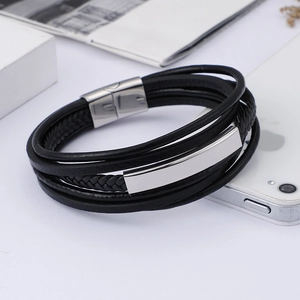 Detail of multi-layer leather bracelet featuring a stainless steel magnetic clasp and plaque