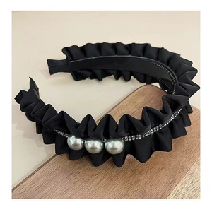Close-up of pleated black fabric headband with silver pearls and rhinestone chain detail