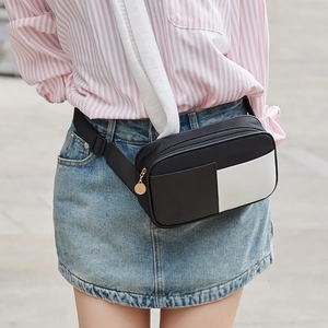 Fashionable black and white nylon waist bag with adjustable strap worn by a model