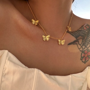 Vintage gold butterfly pendant necklace set with intricate engraved filigree detailing