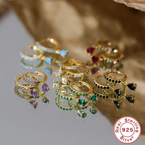 Macro shot of S925 sterling silver hoop earrings with multicolored teardrop gemstones