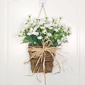 Hanging artificial white daisy basket with green leaves and a natural woven rattan design