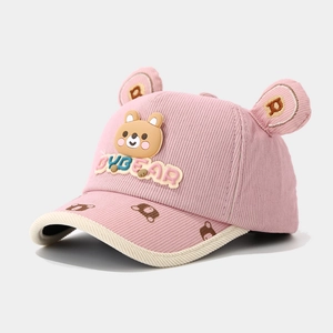 Detailed close-up of pink corduroy kids cap with 3D teddy bear patch and embroidered ears