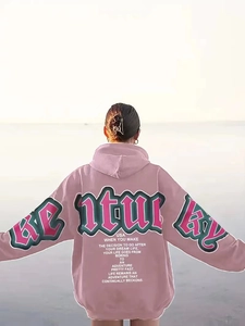 Close-up of vintage Century letter print on a loose-fit dusty pink oversized hoodie