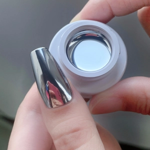 Macro view of silver mirror nail powder creating a high-gloss metallic finish on nails