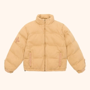Detailed macro view of quilted texture and zipper on khaki insulated explorer jacket