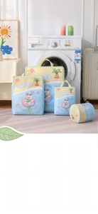 Detailed view of printed blue mesh laundry bags with summer patterns and handles