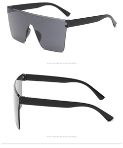 Detail view of large shield sunglasses with wide temples and retro industrial frame