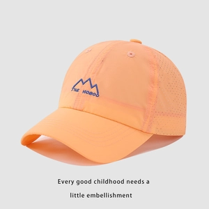Detail view of breathable mesh and embroidered mountain logo on orange quick-dry kids cap