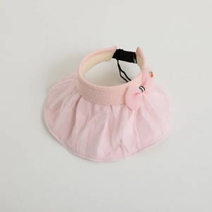 Detail of pink sun visor hat with lace mesh brim and cute carrot charm accessory