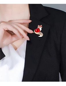 Detail of vintage fox brooch with red crystals pinned on a black suit lapel