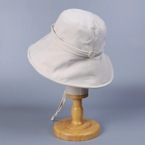 Women's cream wide brim sun hat with decorative button and windproof chin strap