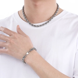 Minimalist silver stainless steel twist chain necklace and bracelet set on a model