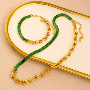 Detail of 18K gold-plated horseshoe link necklace with green rectangle zircon gemstone